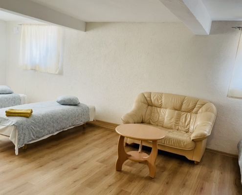 a room with 4 beds on the basement floor of the hostel